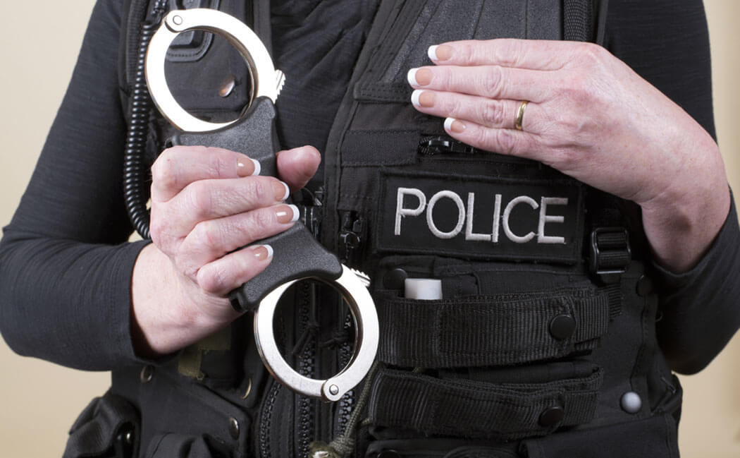 officer-holding a pair of handcuffs